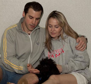Happy couple with dog trained by Pawsitive Paul's Dog Training in Baltimore, MD